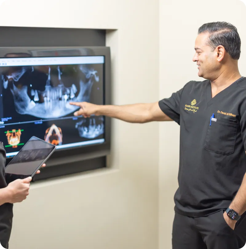 Dr. David H. Gilbert reviewing a 3D X-ray scan with a team member