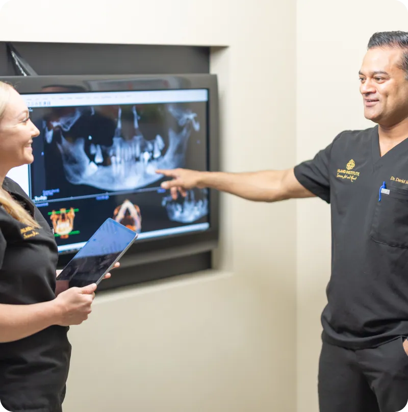 Dr. David H. Gilbert reviewing a 3D X-ray scan with a team member