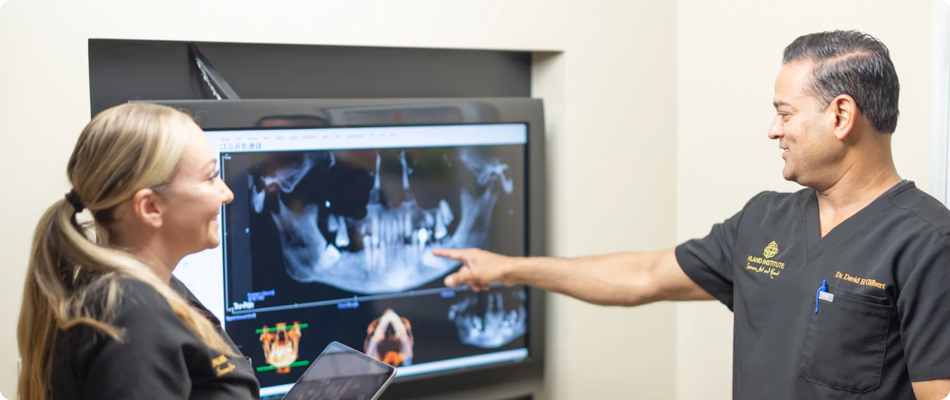 Dr. David H. Gilbert reviewing a 3D X-ray scan with a team member