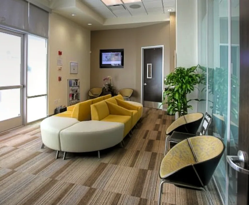 Waiting room with curved sofa and windows