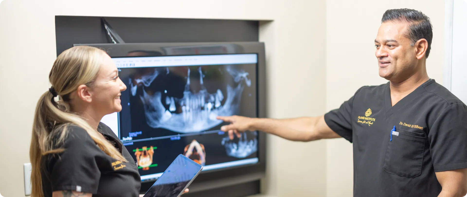 Dr. David H. Gilbert reviewing a 3D X-ray scan with a team member